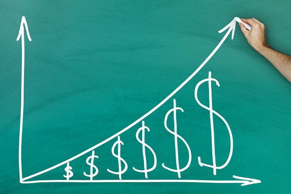 A chalkboard drawing of an upward-trending line with dollar signs under the line.