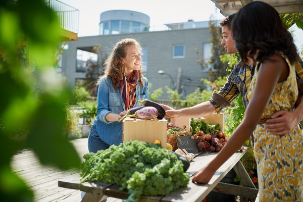 Two people buying food at farmers market